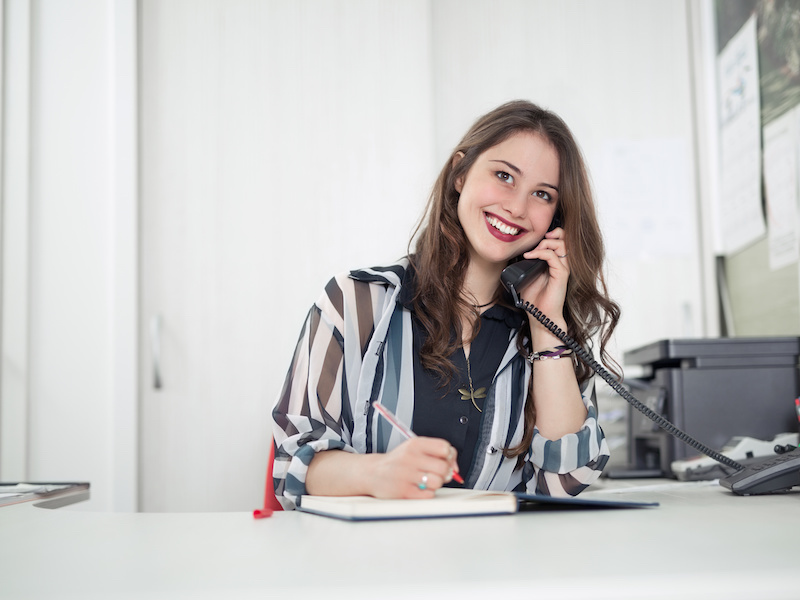 Young Business Woman smiling while talking on the phone